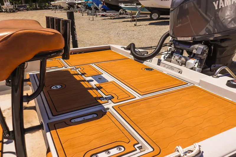 Slide: The Image of 2024 Avid 21 FSX boat deck with Yamaha engine, featuring sleek design and premium seating. - 9