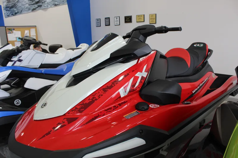The Image of 2026 Yamaha WaveRunner VX Cruiser in showroom, red and white design, side view. - 0