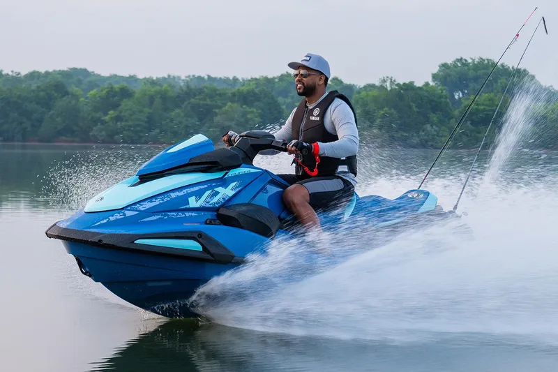 Slide: The Image of Manufacturer Provided Image: 2026 Yamaha WaveRunner VX Cruiser speeding on a lake with a rider. - 8