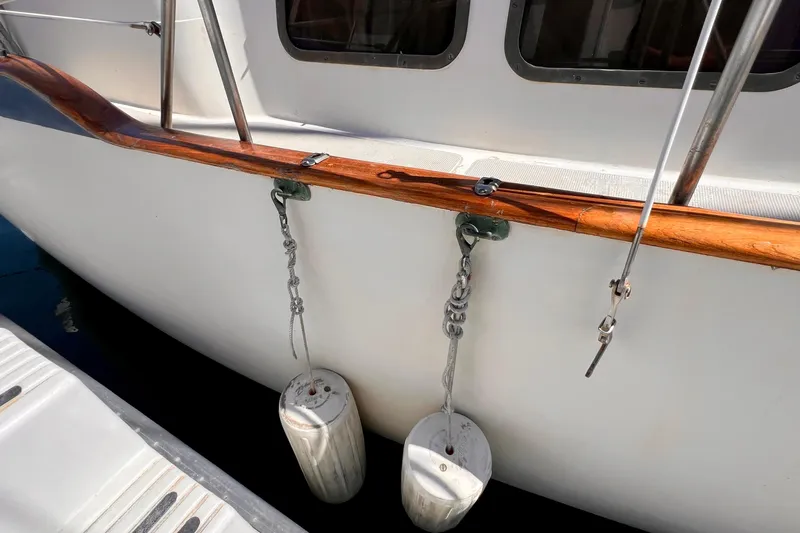 Slide: The Image of 1983 Westsail 42 Center Cockpit with fenders and wooden rail detail. - 10