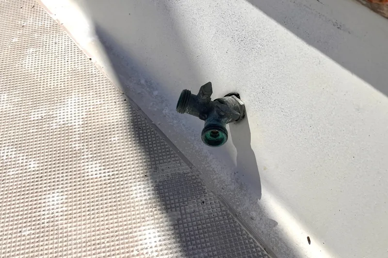 Slide: The Image of Weathered faucet on 1983 Westsail 42 Center Cockpit deck, textured surface. - 16