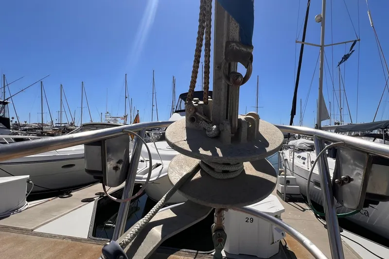 Slide: The Image of Westsail 42 Center Cockpit sailboat, 1983 model, docked at marina with clear blue sky. - 18