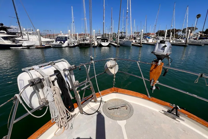 Slide: The Image of 1983 Westsail 42 Center Cockpit sailboat docked in a marina with clear blue skies. - 19