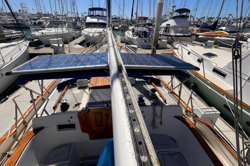 Slide: The Image of 1983 Westsail 42 Center Cockpit sailboat with solar panels, docked in a marina. - 20