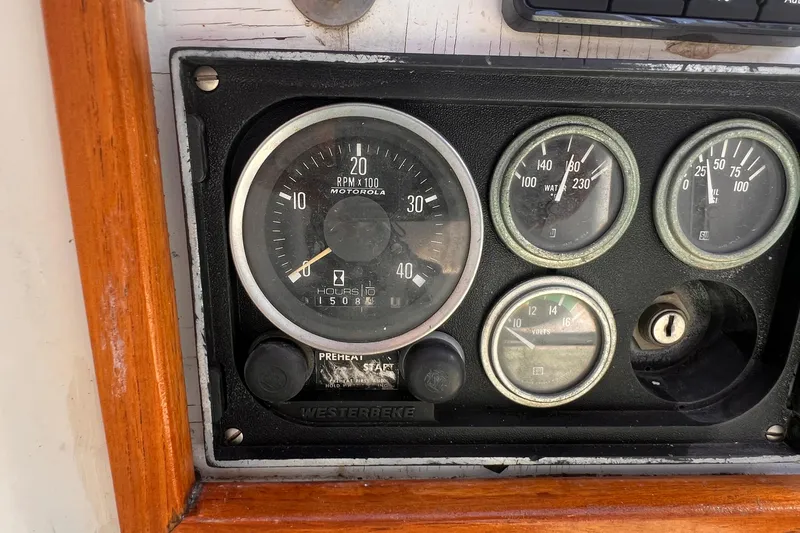 Slide: The Image of Instrument panel of a 1983 Westsail 42 Center Cockpit sailboat, featuring gauges and controls. - 22