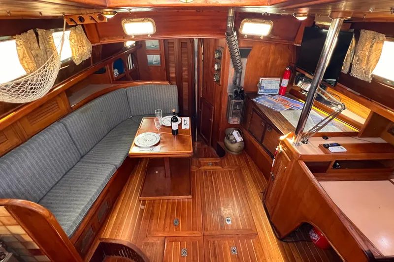 Slide: The Image of Cozy interior of 1983 Westsail 42 Center Cockpit sailboat with wooden furnishings. - 23