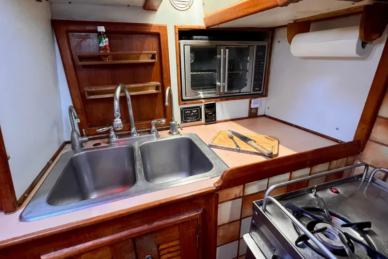 Slide: The Image of Galley kitchen in 1983 Westsail 42 Center Cockpit with double sink and stove. - 26