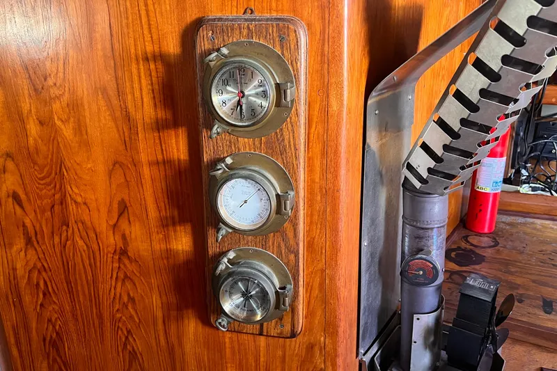 Slide: The Image of Interior of 1983 Westsail 42 Center Cockpit with nautical instruments and wood paneling. - 29