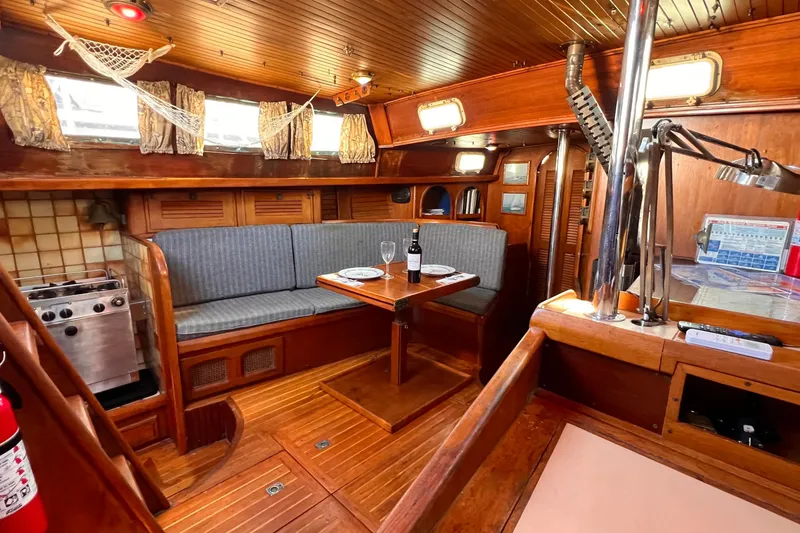 Slide: The Image of Interior of 1983 Westsail 42 Center Cockpit yacht with cozy dining area and wooden finishes. - 30