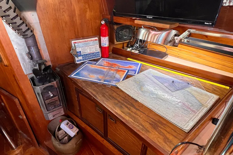 Slide: The Image of Navigation station on 1983 Westsail 42 Center Cockpit with maps and equipment. - 31