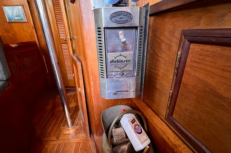 Slide: The Image of 1983 Westsail 42 Center Cockpit interior with Dickinson heater and wooden paneling. - 32