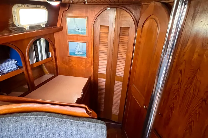 Slide: The Image of Interior of 1983 Westsail 42 Center Cockpit with wooden cabinetry and nautical decor. - 36