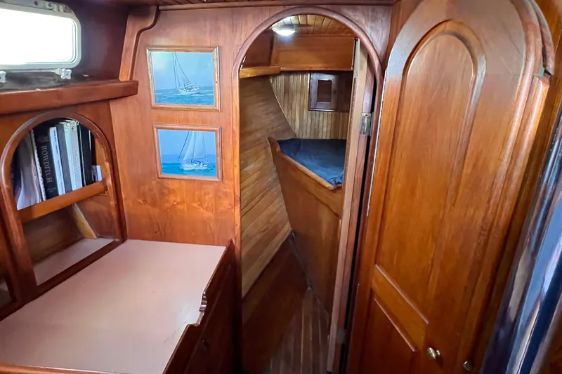 Slide: The Image of Interior of 1983 Westsail 42 Center Cockpit with wooden cabinetry and cozy sleeping area. - 37