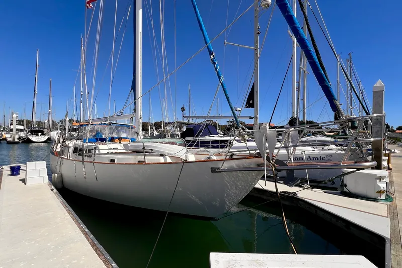 Slide: The Image of 1983 Westsail 42 Center Cockpit sailboat docked at marina under clear blue sky. - 4