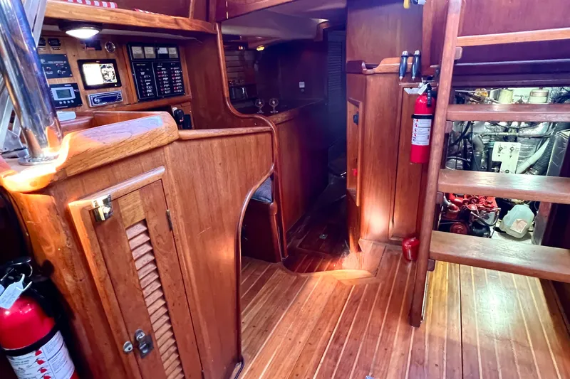 Slide: The Image of Interior of 1983 Westsail 42 Center Cockpit with wooden finish and engine room access. - 42