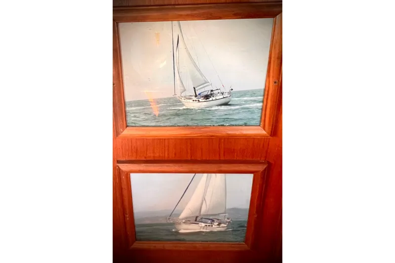 Slide: The Image of Framed photos of a 1983 Westsail 42 Center Cockpit sailboat on the ocean. - 47