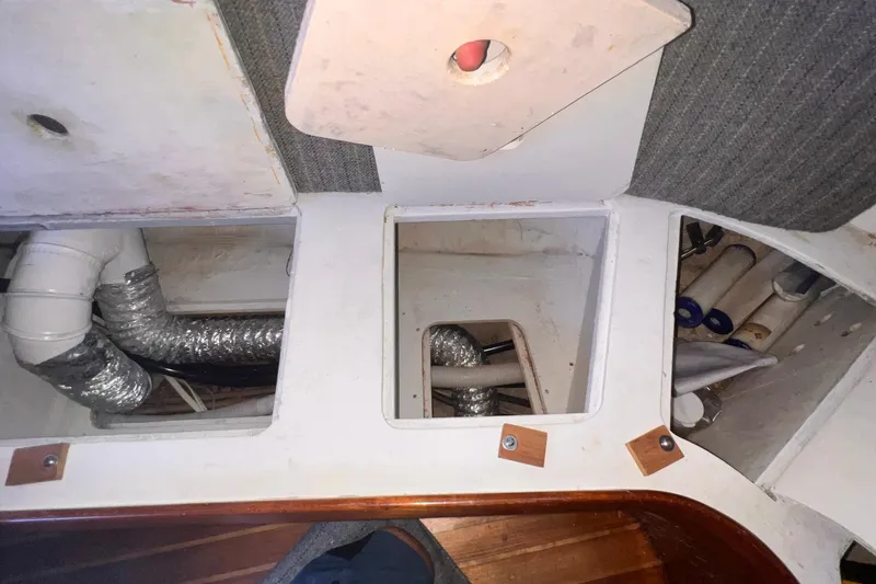 Slide: The Image of Interior view of 1983 Westsail 42 Center Cockpit showing storage compartments and ductwork. - 56