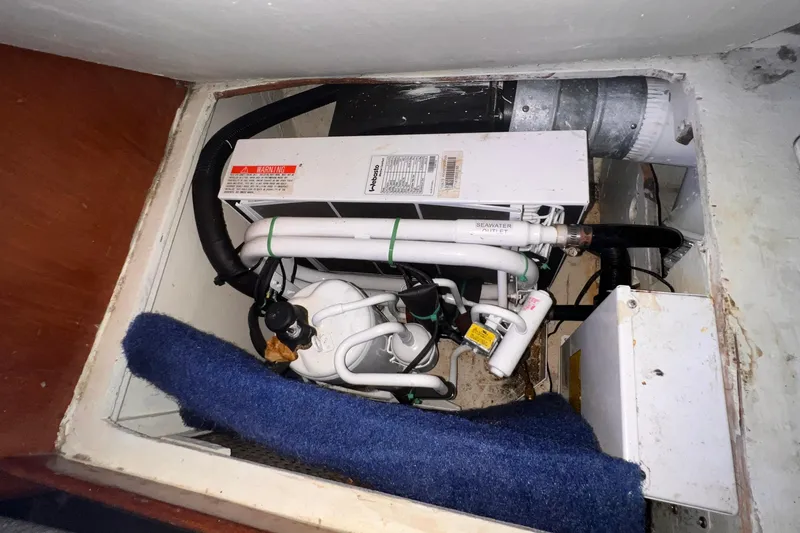 Slide: The Image of Engine compartment of a 1983 Westsail 42 Center Cockpit sailboat, showing mechanical components. - 57