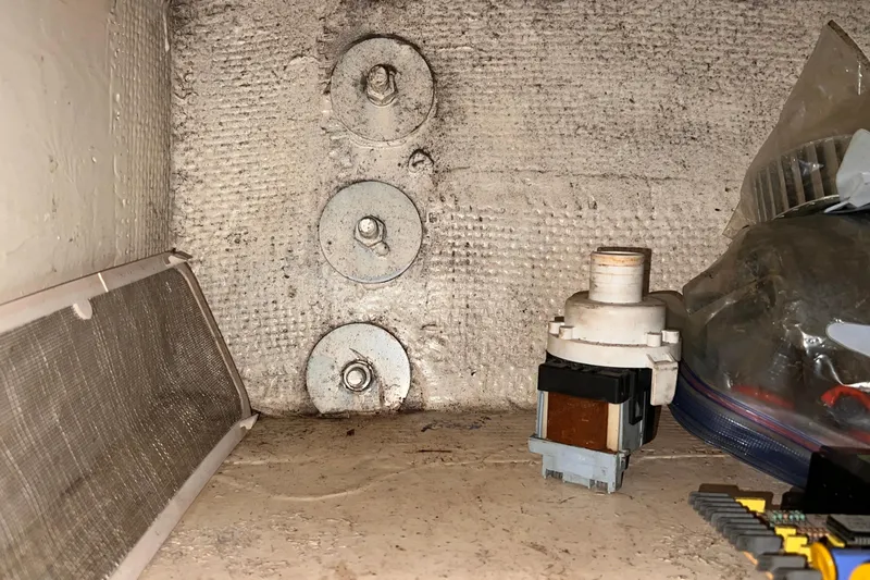 Slide: The Image of Interior view of a 1983 Westsail 42 Center Cockpit, showing mechanical components and storage. - 58