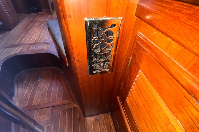 Slide: The Image of Wooden interior of 1983 Westsail 42 Center Cockpit with decorative metal vent. - 60