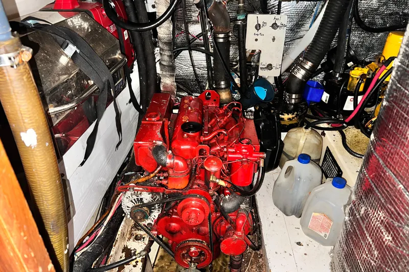Slide: The Image of Engine room of 1983 Westsail 42 Center Cockpit with red engine and equipment. - 63