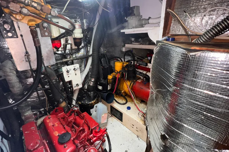 Slide: The Image of Engine room of a 1983 Westsail 42 Center Cockpit sailboat, featuring various mechanical components. - 65