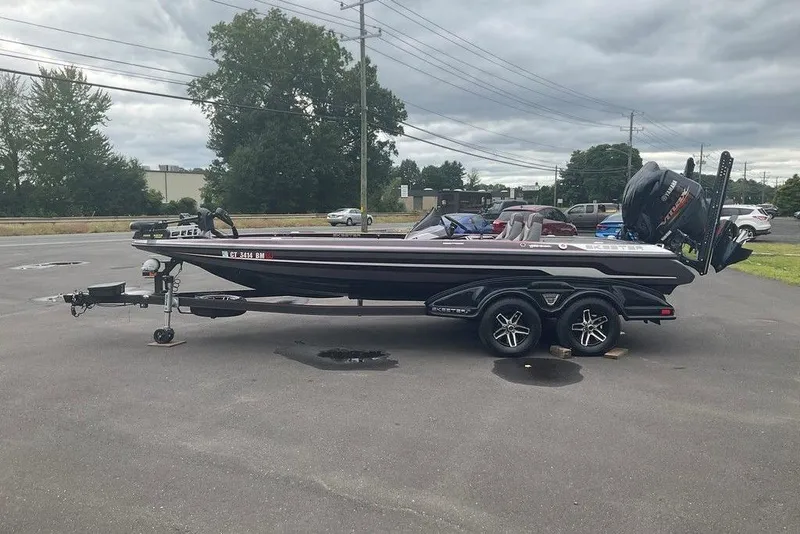 Slide: The Image of 2017 Skeeter FX21 LE bass boat on trailer in parking lot, overcast sky. - 12