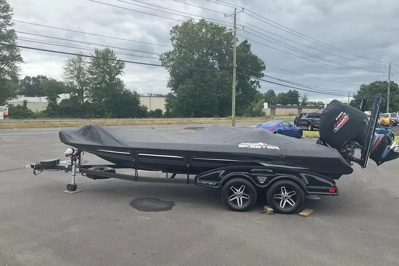 Slide: The Image of 2017 Skeeter FX21 LE boat covered on trailer in parking lot. - 15