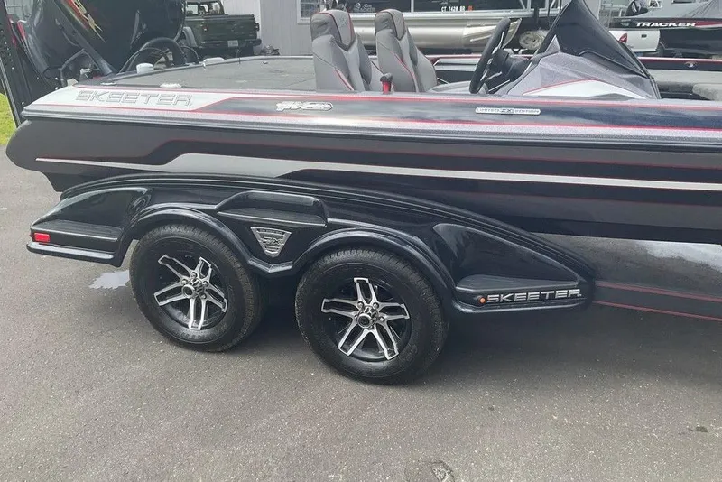 Slide: The Image of 2017 Skeeter FX21 LE boat on a trailer with sleek design and dual wheels. - 26
