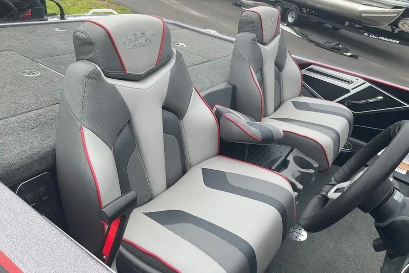 Slide: The Image of 2017 Skeeter FX21 LE boat interior with gray and red seats, steering wheel, and console. - 37