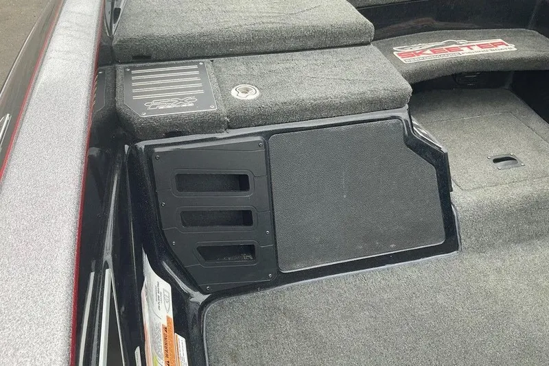 Slide: The Image of 2017 Skeeter FX21 LE boat interior with carpeted deck and storage compartments. - 40