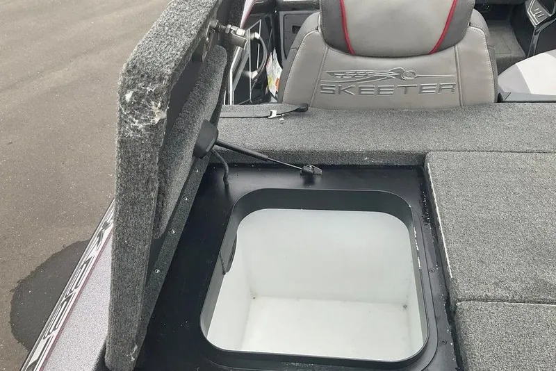 Slide: The Image of 2017 Skeeter FX21 LE boat interior with open storage compartment and branded seat. - 43