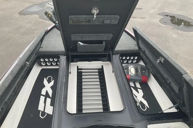 Slide: The Image of 2017 Skeeter FX21 LE boat storage compartments with open lids and organized interior. - 47