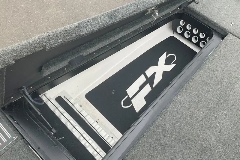 Slide: The Image of 2017 Skeeter FX21 LE boat storage compartment with rod holders and FX logo. - 48