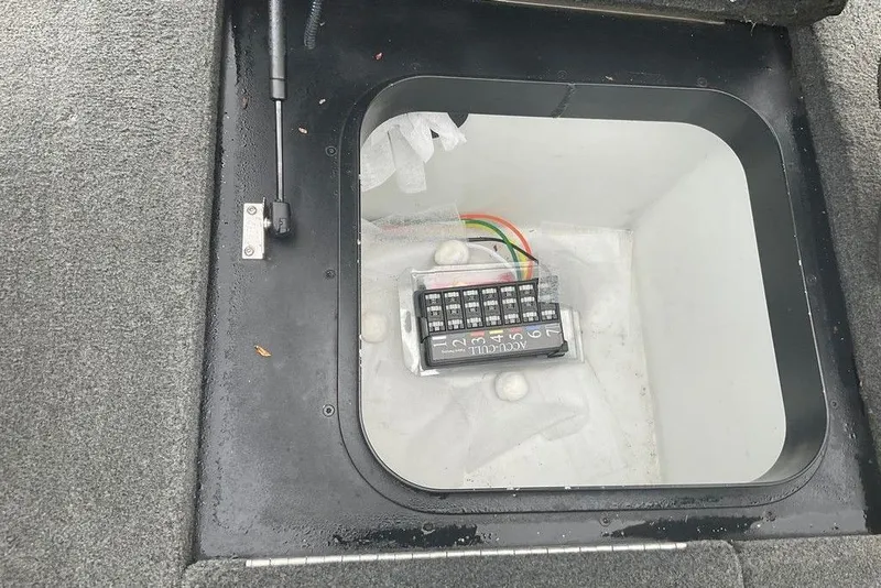 Slide: The Image of 2017 Skeeter FX21 LE storage compartment with electrical panel and wiring. - 49