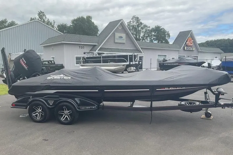 Slide: The Image of 2017 Skeeter FX21 LE boat covered, parked at dealership with other boats. - 8