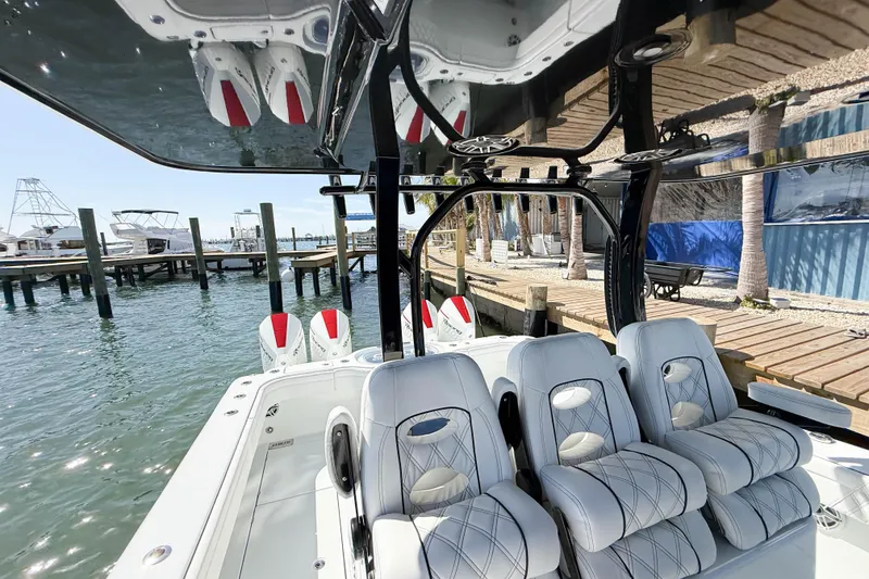 Slide: The Image of 2023 Costa Custom Boats 34 model with luxurious seating at a marina dock. - 10