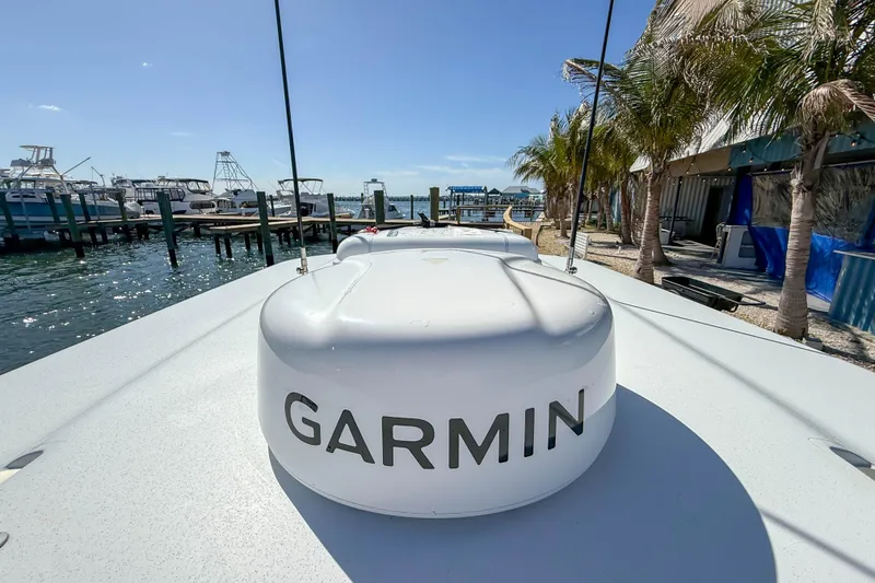 Slide: The Image of 2023 Costa Custom Boats 34 with Garmin equipment docked at a marina. - 14