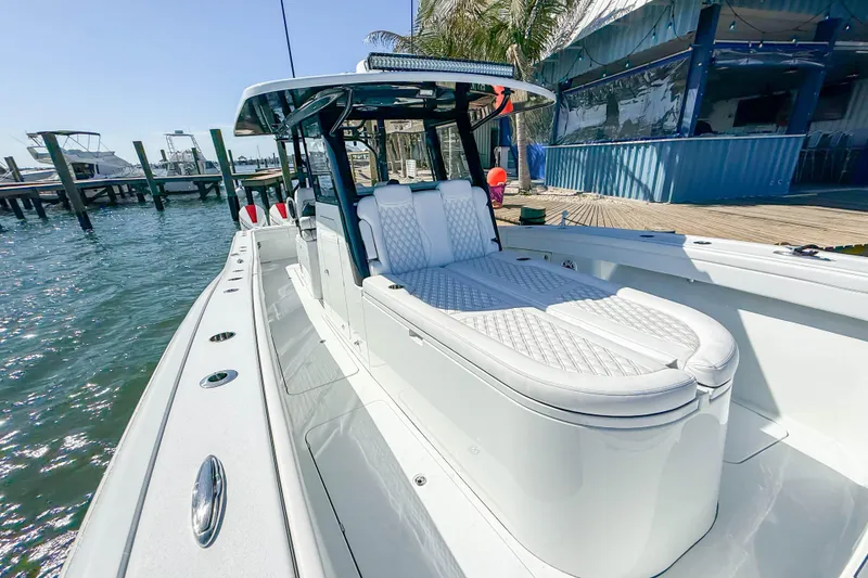 Slide: The Image of 2023 Costa Custom Boats 34 model docked, featuring sleek design and luxurious seating. - 16