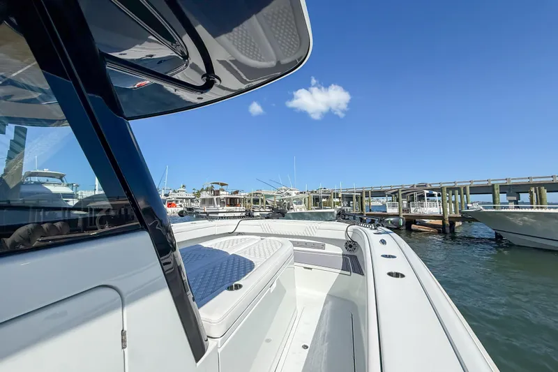 Slide: The Image of 2023 Costa Custom Boats 34 docked at marina under clear blue sky. - 19