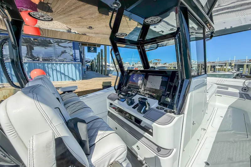 Slide: The Image of 2023 Costa Custom Boats 34 cockpit with advanced navigation system and luxurious seating. - 20