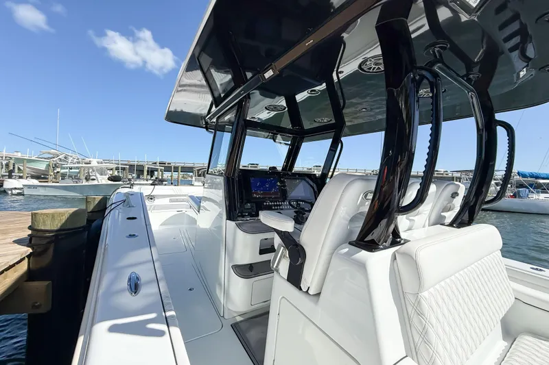 Slide: The Image of 2023 Costa Custom Boats 34 at dock, featuring sleek design and modern cockpit. - 24