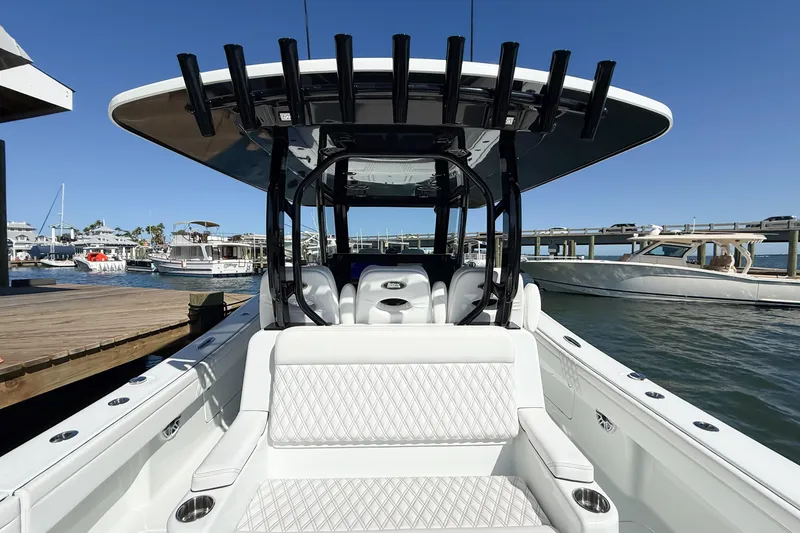 Slide: The Image of 2023 Costa Custom Boats 34 at marina, showcasing sleek design and luxurious seating. - 27