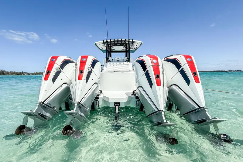 Slide: The Image of 2023 Costa Custom Boats 34 with four powerful outboard engines in clear blue water. - 3