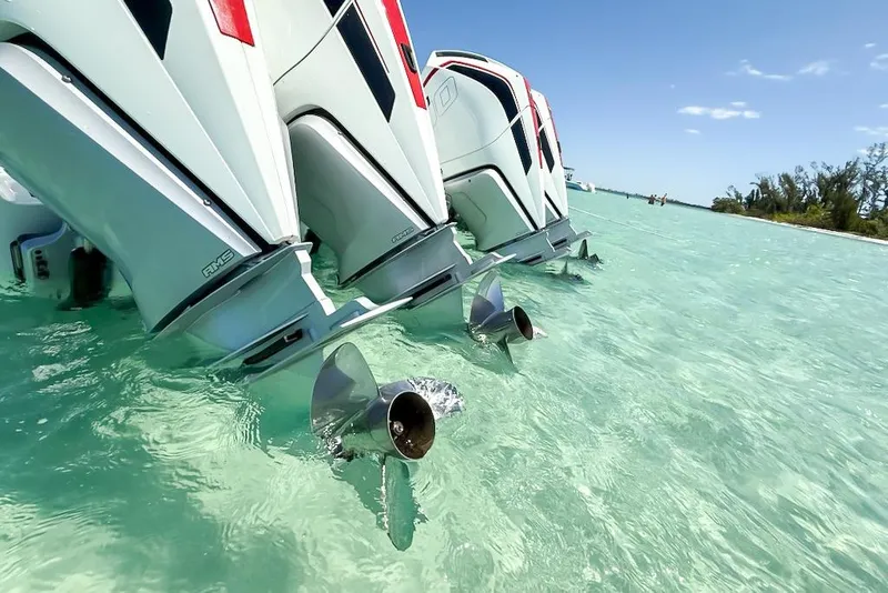 Slide: The Image of Triple outboard motors on a 2023 Costa Custom Boats 34 in clear turquoise water. - 4