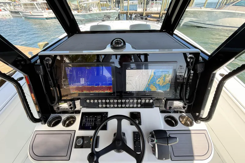Slide: The Image of Helm of 2023 Costa Custom Boats 34 with advanced navigation displays and controls. - 7