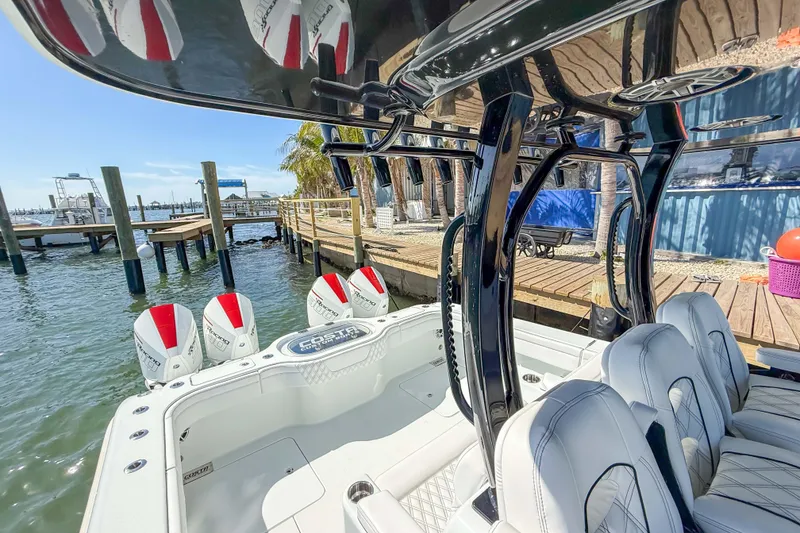 Slide: The Image of 2023 Costa Custom Boats 34 model docked, showcasing sleek design and powerful engines. - 8