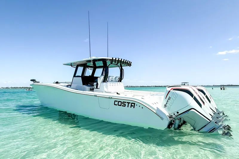 The Image of 2023 Costa Custom Boats 34 in clear turquoise water, showcasing sleek design and powerful engines. - 0