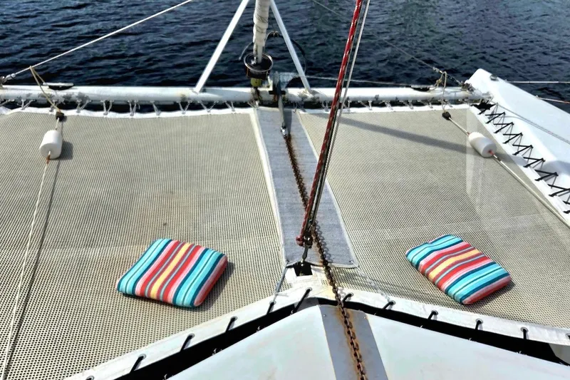 Slide: The Image of Catamaran St. Francis 43 deck with striped cushions, 1995 model, on calm water. - 10