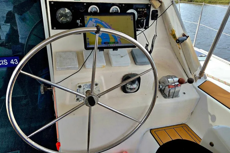 Slide: The Image of Helm of 1995 Catamaran St. Francis 43 with navigation equipment and steering wheel. - 17